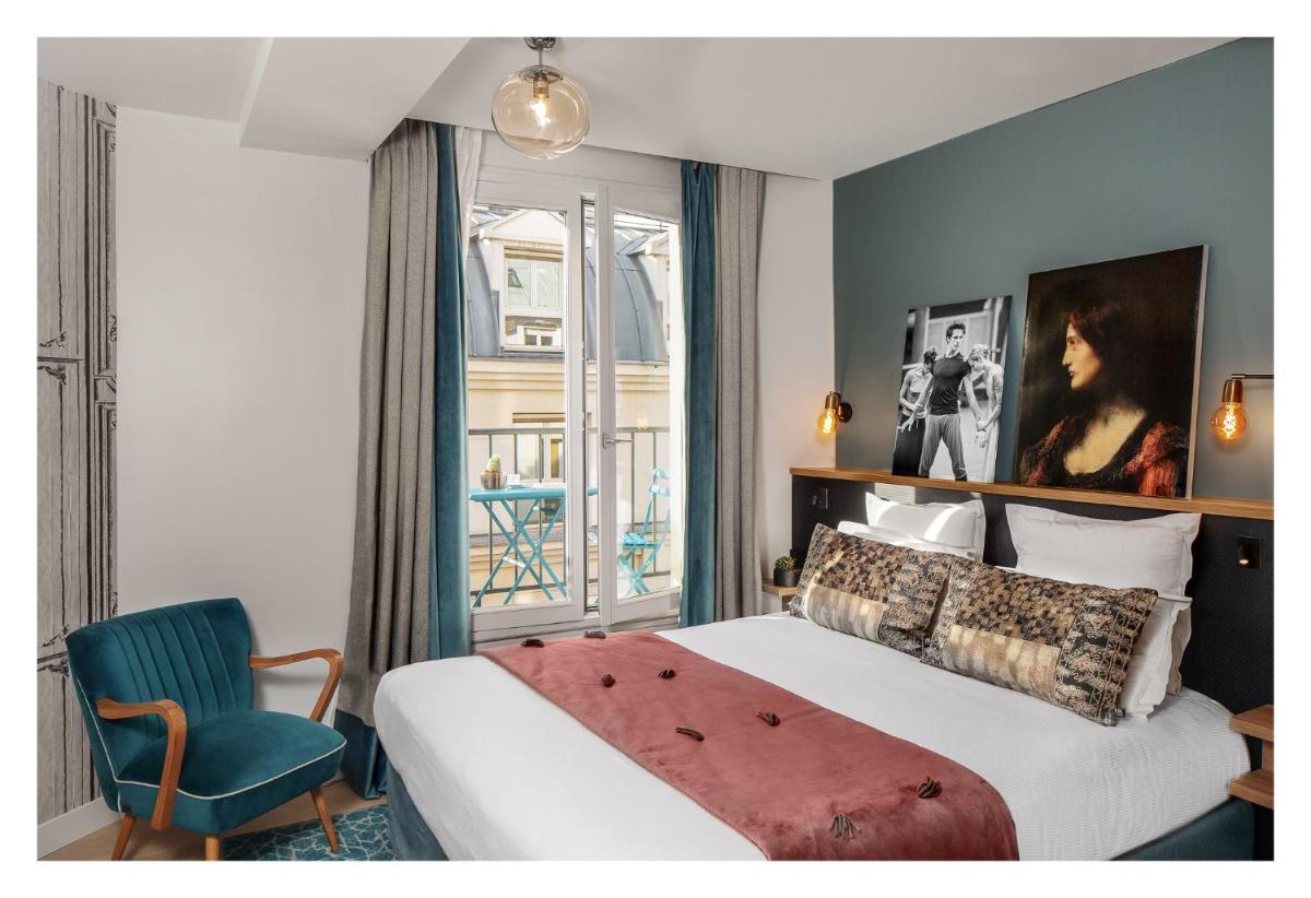 Un ou plusieurs lits dans un hébergement de l'établissement Lyric Hotel Paris Opera