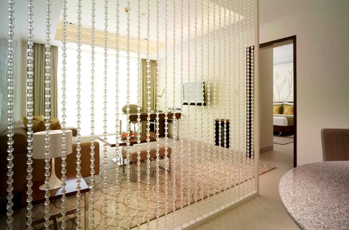 a glass display case in a living room at Taj Yeshwantpur Bengaluru in Bengaluru a glass display case in a living room at Taj Yeshwantpur Bengaluru in Bengaluru