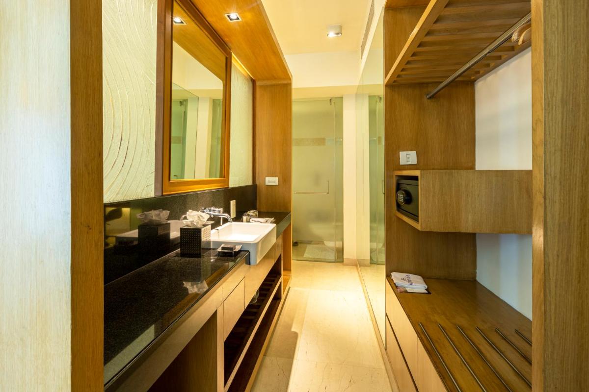 a bathroom with a sink and a mirror at Vivanta Bengaluru, Whitefield in Bengaluru