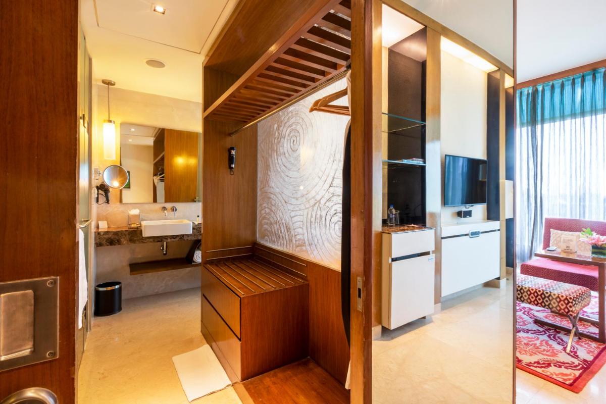 a room with a bathroom with a sink and a mirror at Vivanta Bengaluru, Whitefield in Bengaluru