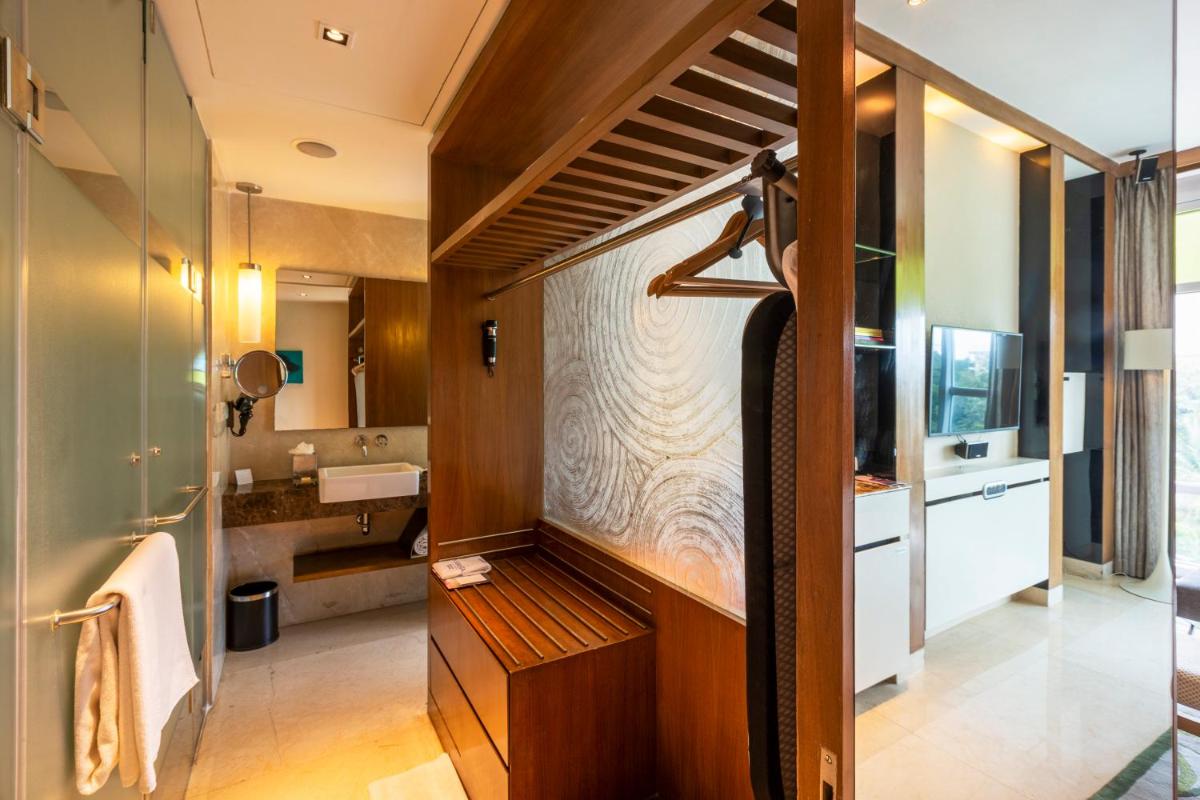 a bathroom with a sink and a toilet in a room at Vivanta Bengaluru, Whitefield in Bengaluru