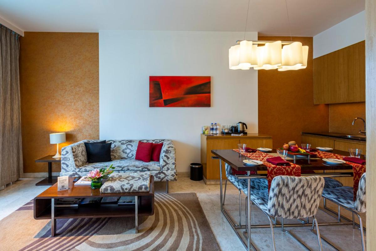 a living room with a couch and a table at Vivanta Bengaluru, Whitefield in Bengaluru