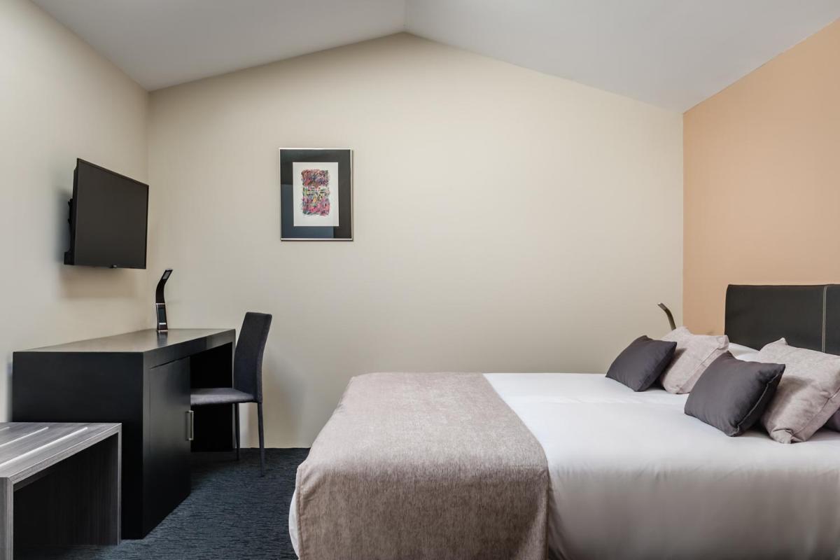Cama o camas de una habitación en Hotel Balneario Orduña Plaza