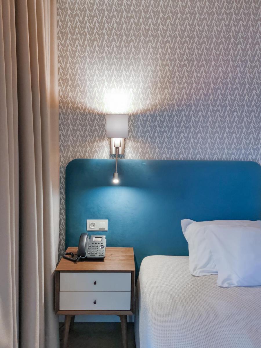 Uma cama ou camas num quarto em Hotel Vouga