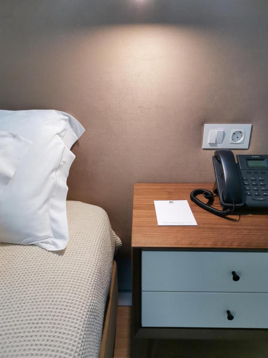 Uma cama ou camas num quarto em Hotel Vouga
