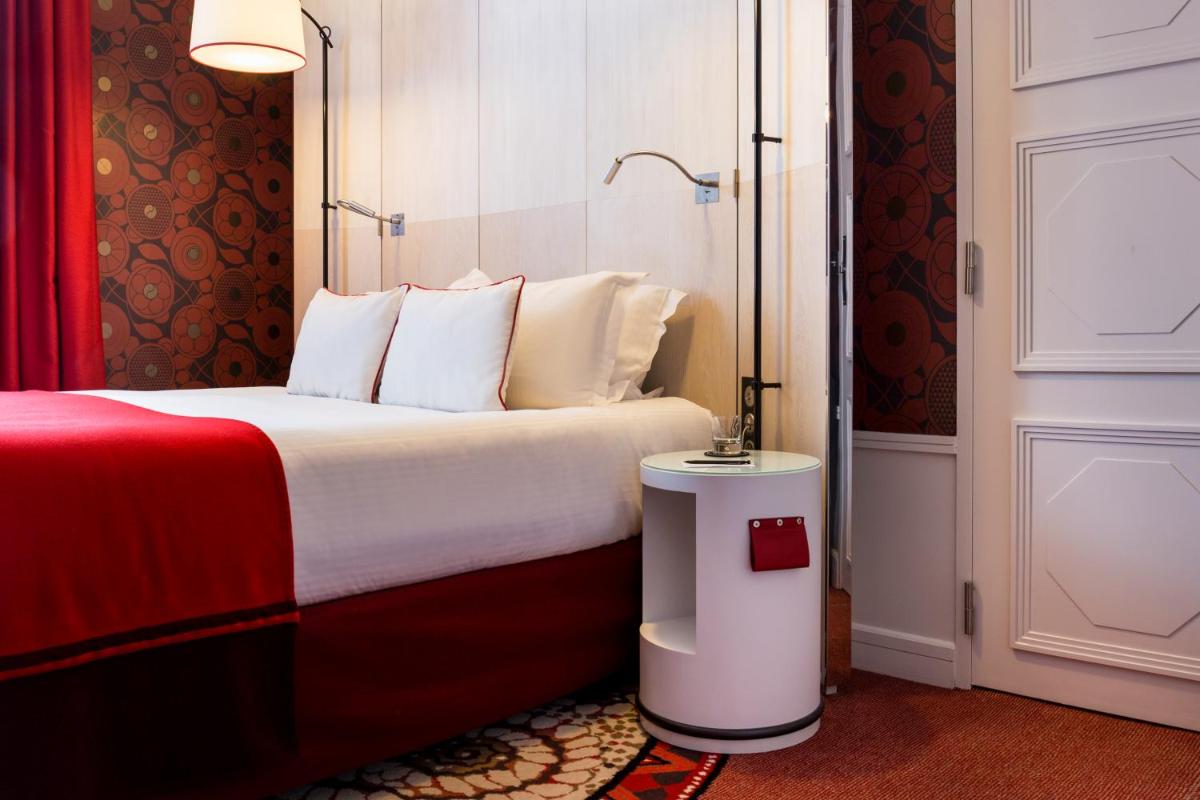 Un ou plusieurs lits dans un hébergement de l'établissement Carlton Hotel Lyon - MGallery Collection
