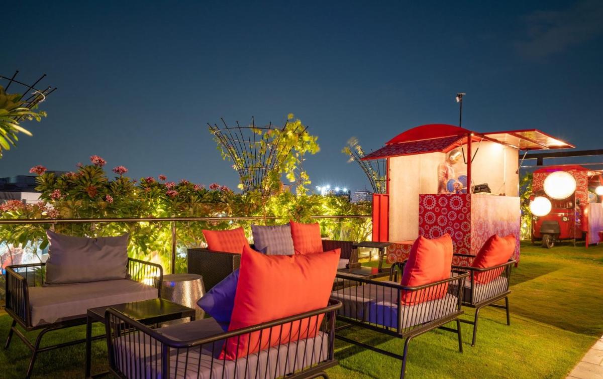 a group of chairs and tables on a patio at Hyatt Place Hyderabad Banjara Hills in Hyderabad