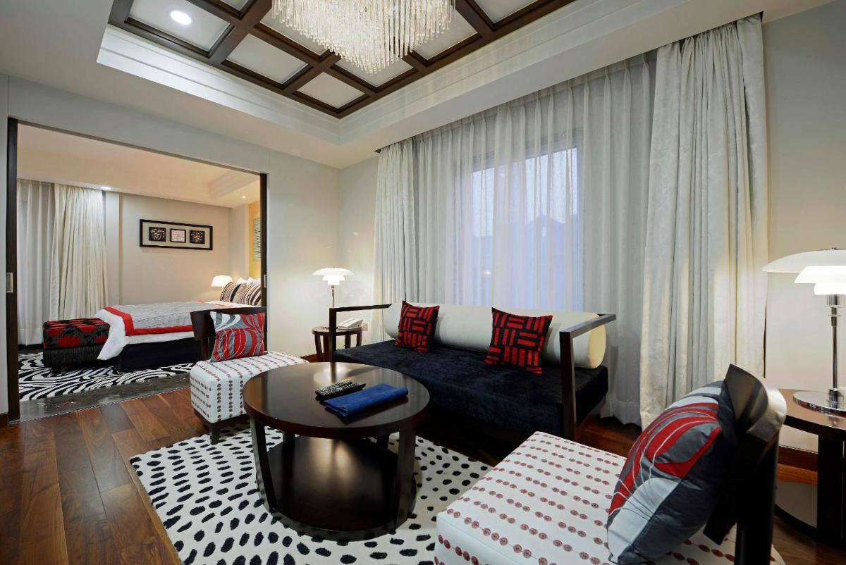 a living room with a couch and a table at Radisson Blu Hotel Ahmedabad in Ahmedabad