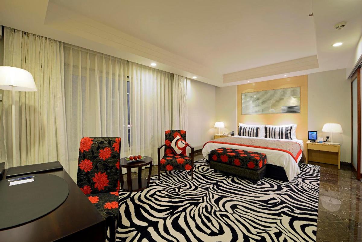 a hotel room with a bed and a zebra carpet at Radisson Blu Hotel Ahmedabad in Ahmedabad