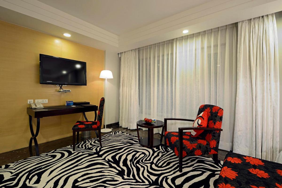 a hotel room with a zebra print bed and a desk at Radisson Blu Hotel Ahmedabad in Ahmedabad