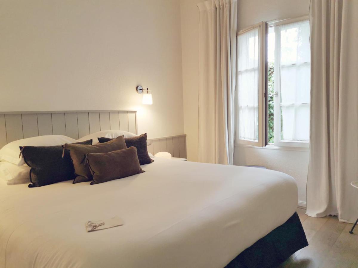 Un ou plusieurs lits dans un hébergement de l'établissement Le Clos Saint-Martin Hôtel & Spa