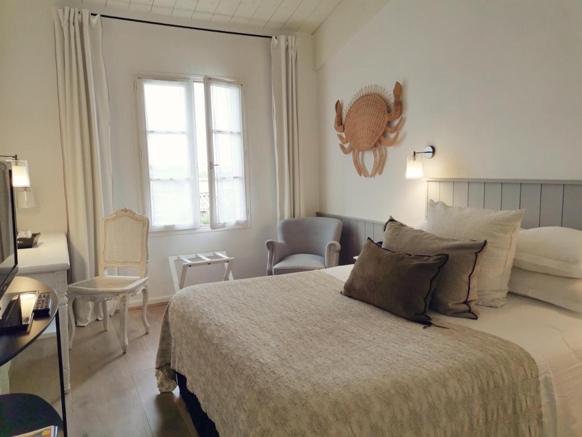 Un ou plusieurs lits dans un hébergement de l'établissement Le Clos Saint-Martin Hôtel & Spa
