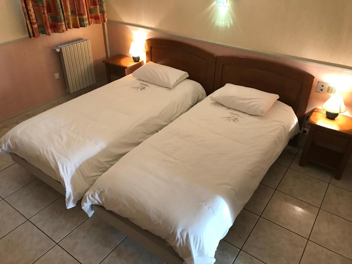 Un ou plusieurs lits dans un hébergement de l'établissement Hotel et Résidence Le Clos Cerdan
