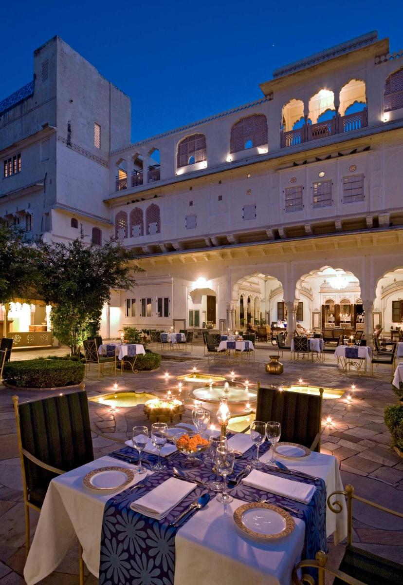 a table in front of a building at night at Samode Haveli in Jaipur