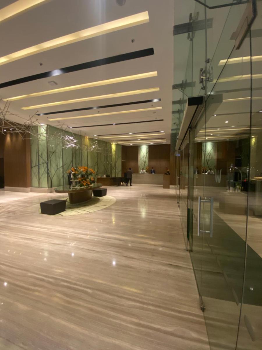 an empty lobby with a glass wall in a building at Welcomhotel by ITC Hotels, Richmond Road, Bengaluru in Bengaluru