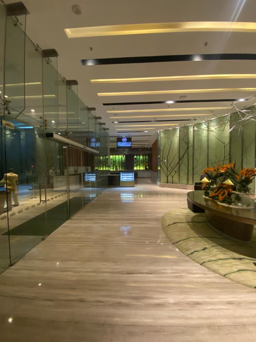 an empty lobby of a building with glass walls at Welcomhotel by ITC Hotels, Richmond Road, Bengaluru in Bengaluru