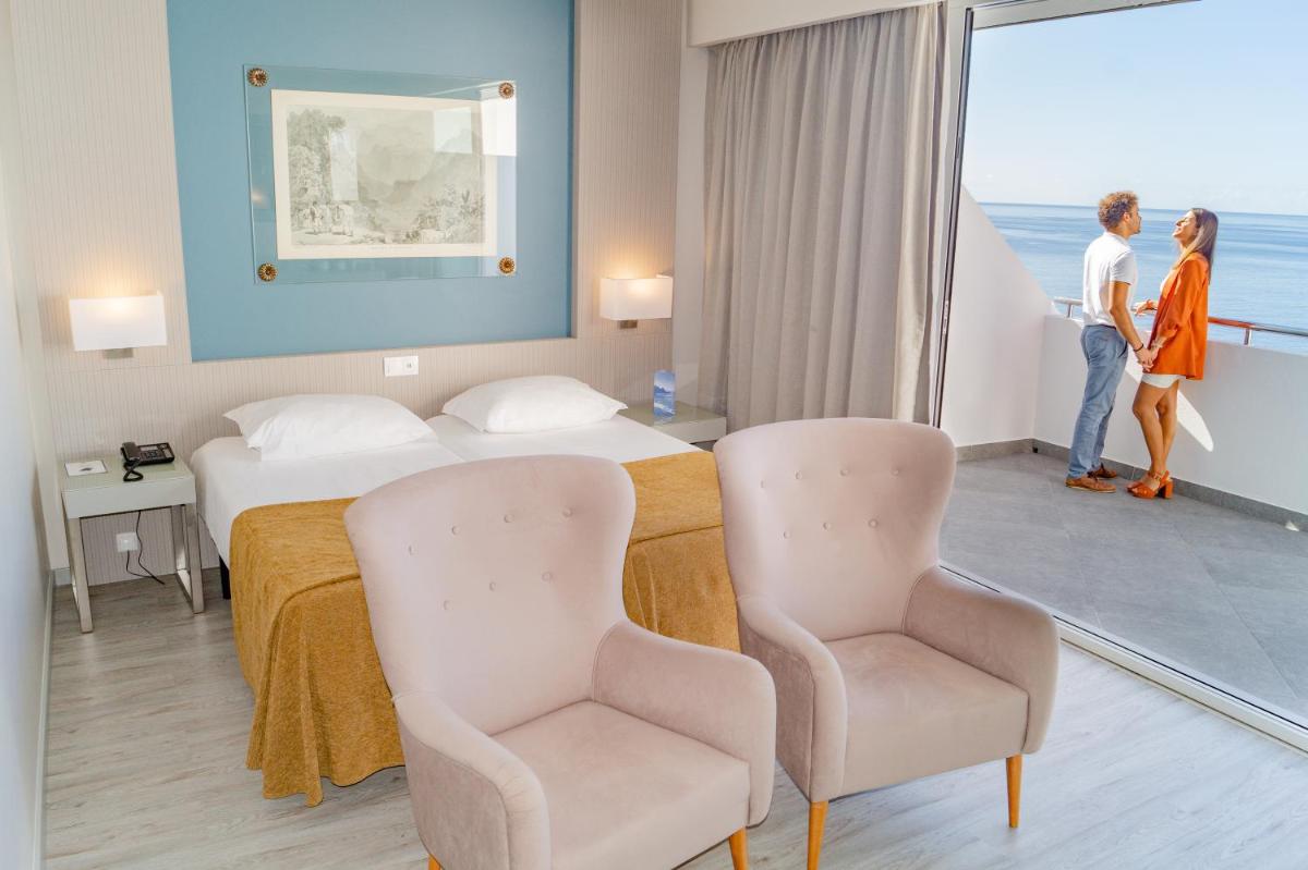 Uma cama ou camas num quarto em Hotel Orca Praia