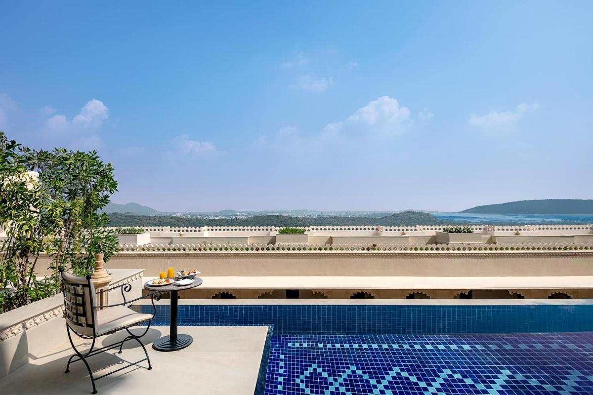 a view of the pool from the balcony of a building at Aurika, Udaipur - Luxury by Lemon Tree Hotels in Udaipur