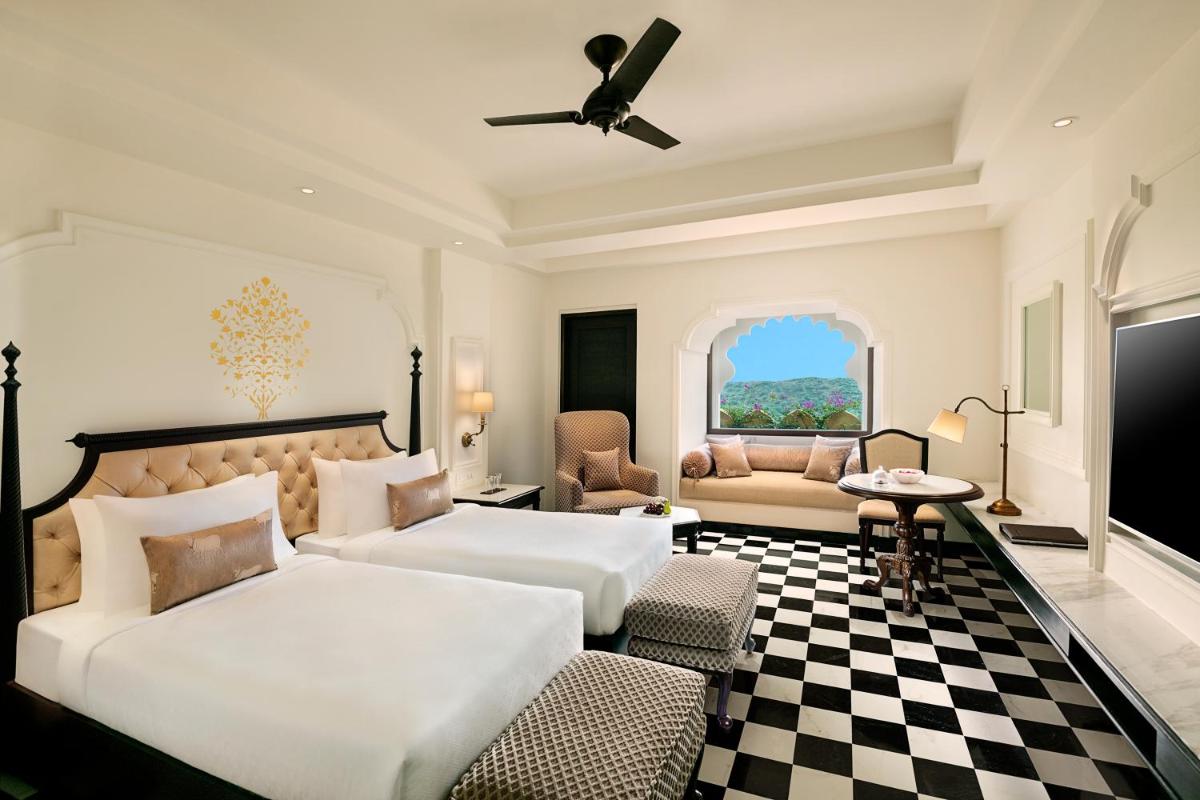 a bedroom with two beds and a checkerboard floor at Aurika, Udaipur - Luxury by Lemon Tree Hotels in Udaipur