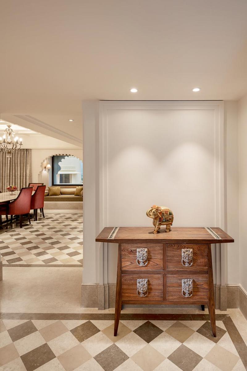 a living room with a wooden dresser and a dining room at Aurika, Udaipur - Luxury by Lemon Tree Hotels in Udaipur