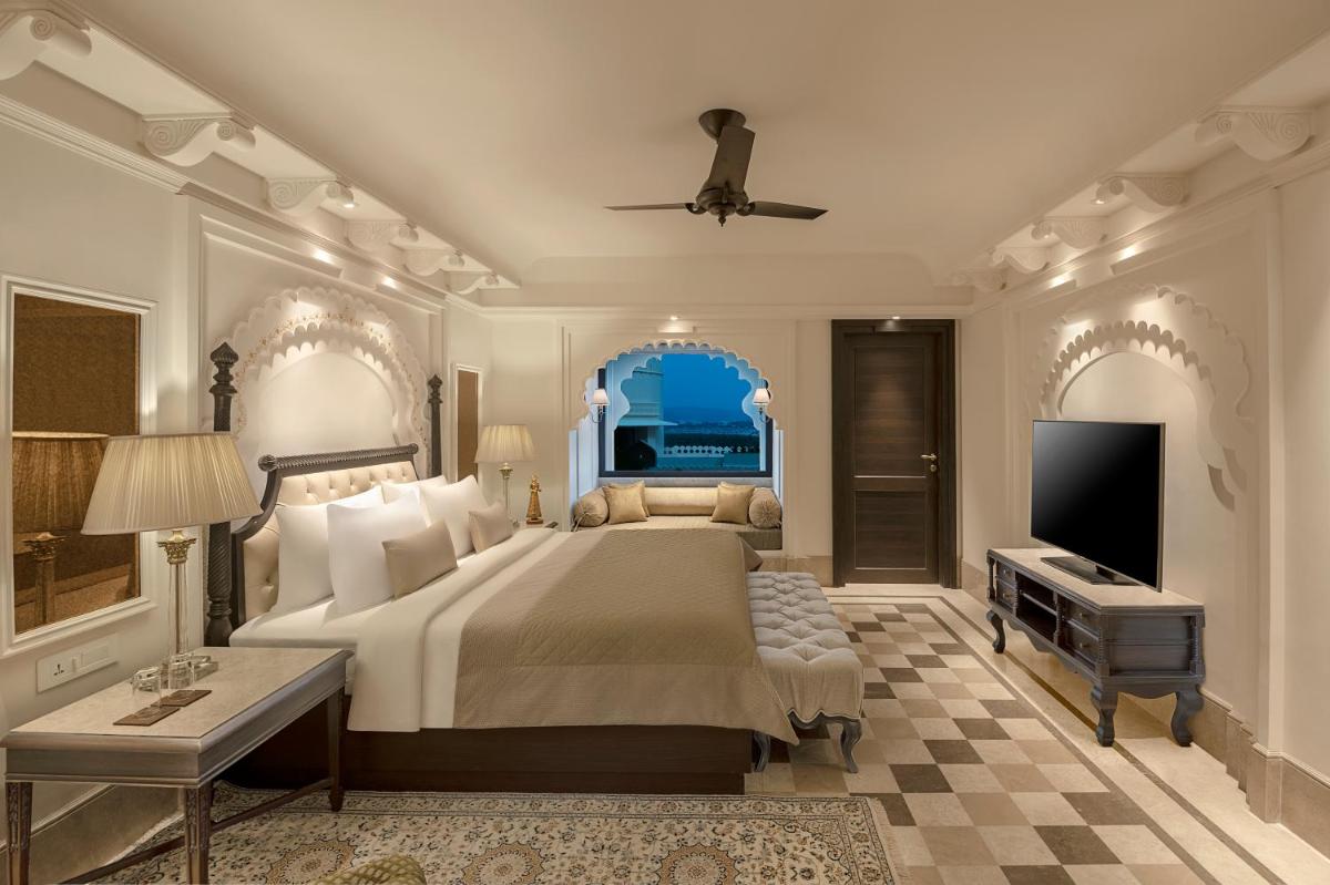 a bedroom with a large bed and a tv at Aurika, Udaipur - Luxury by Lemon Tree Hotels in Udaipur