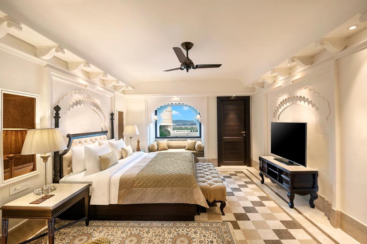 a bedroom with a bed and a flat screen tv at Aurika, Udaipur - Luxury by Lemon Tree Hotels in Udaipur