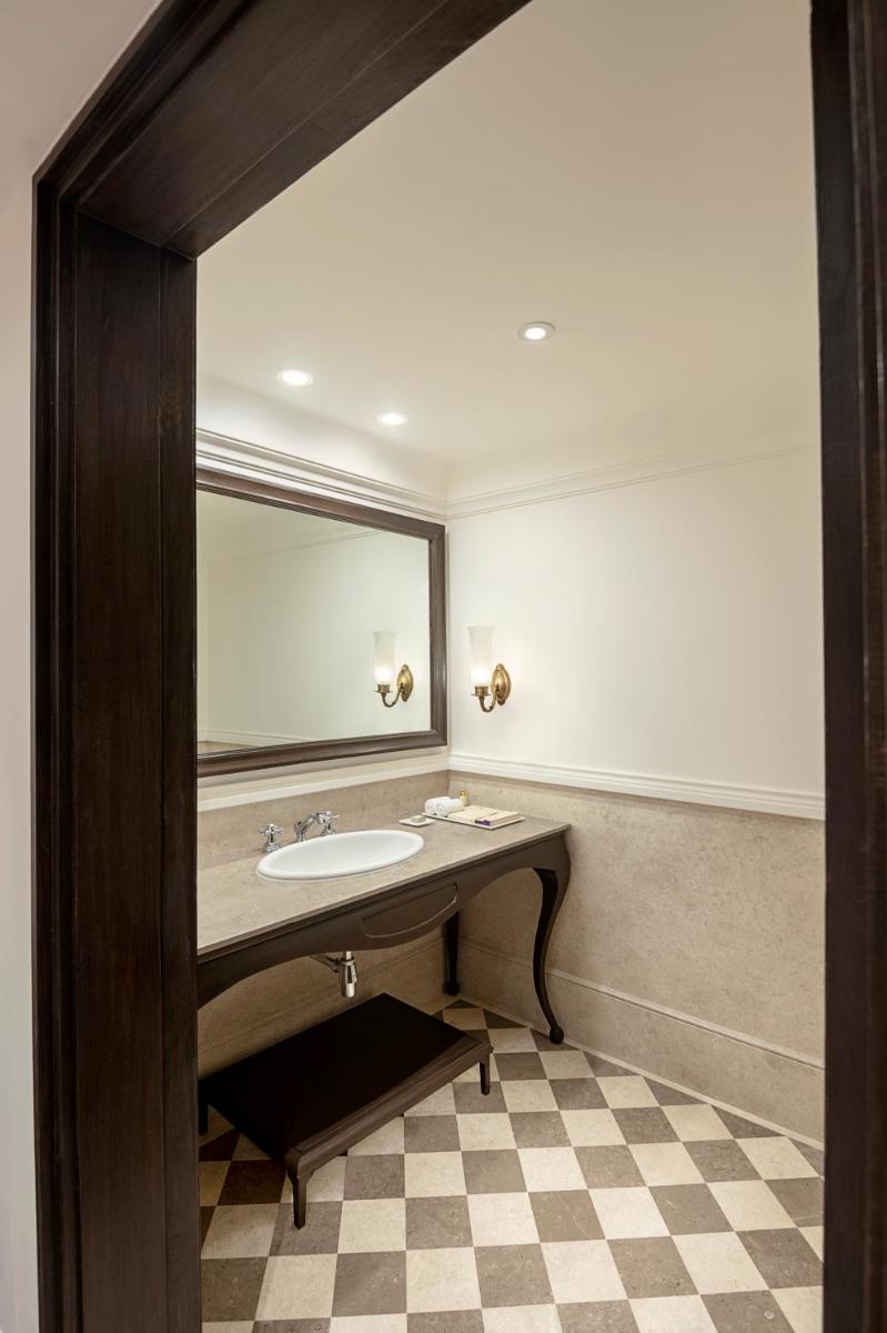 a bathroom with a sink and a mirror at Aurika, Udaipur - Luxury by Lemon Tree Hotels in Udaipur