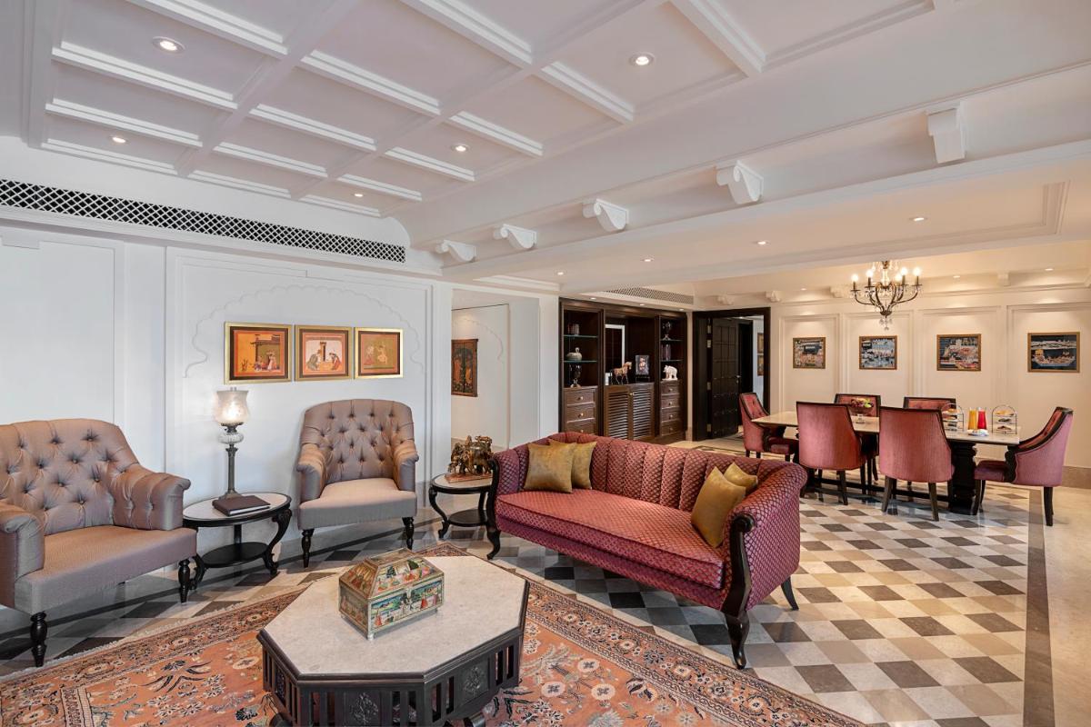 a living room with couches and a table at Aurika, Udaipur - Luxury by Lemon Tree Hotels in Udaipur