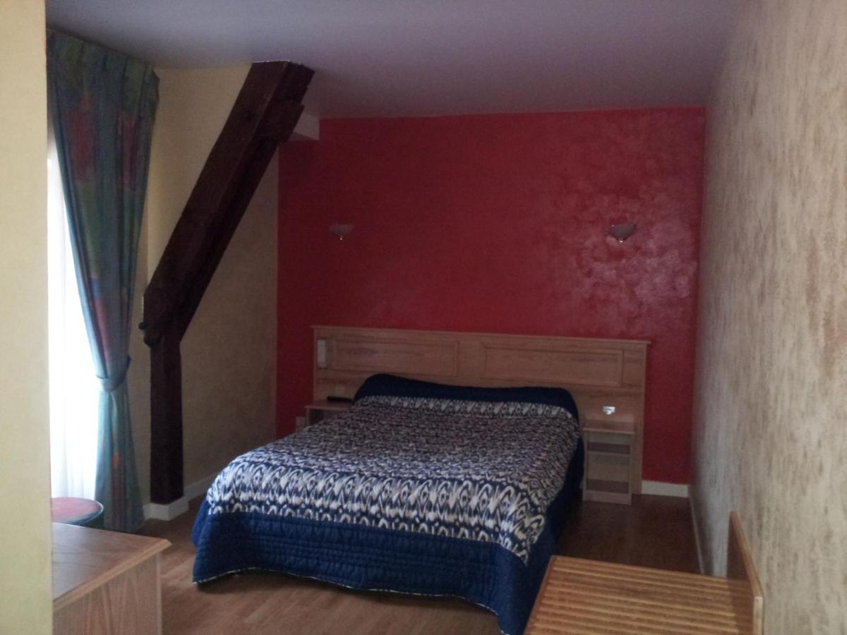 Un ou plusieurs lits dans un hébergement de l'établissement Maison Legate "Hôtel Le Baudiere & Spa"