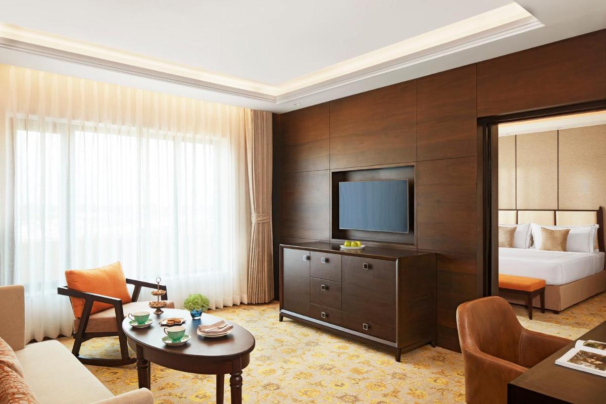 a hotel room with a bed and a television at Taj Tirupati in Tirupati