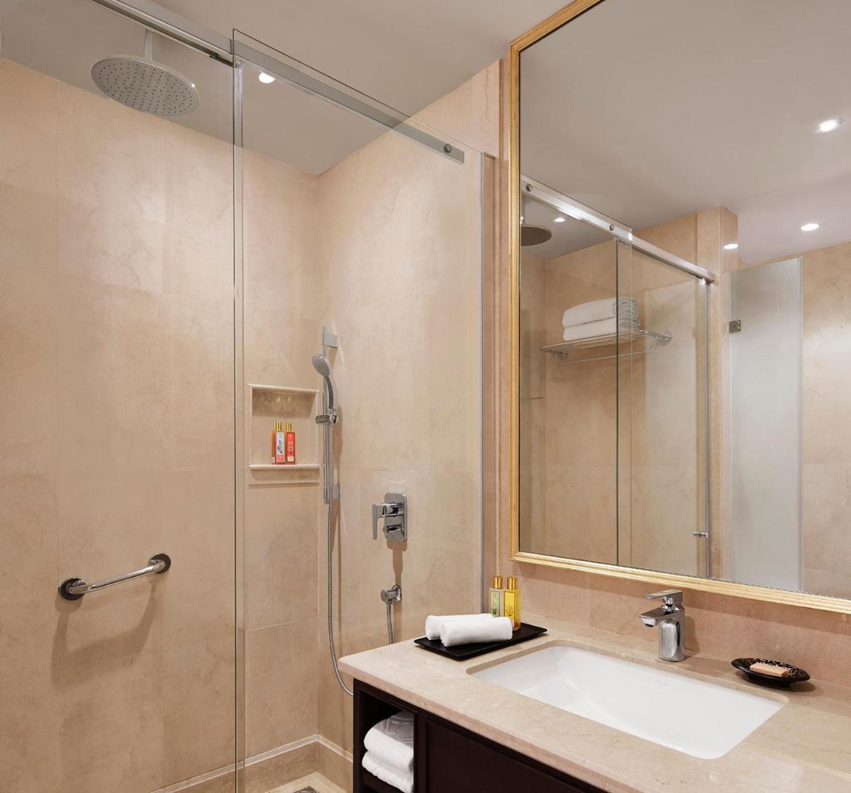 a bathroom with a sink and a shower at Taj Tirupati in Tirupati