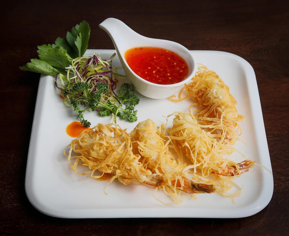 a plate of food with pasta and a dipping sauce at Welcomhotel by ITC Hotels, Shimla in Shimla