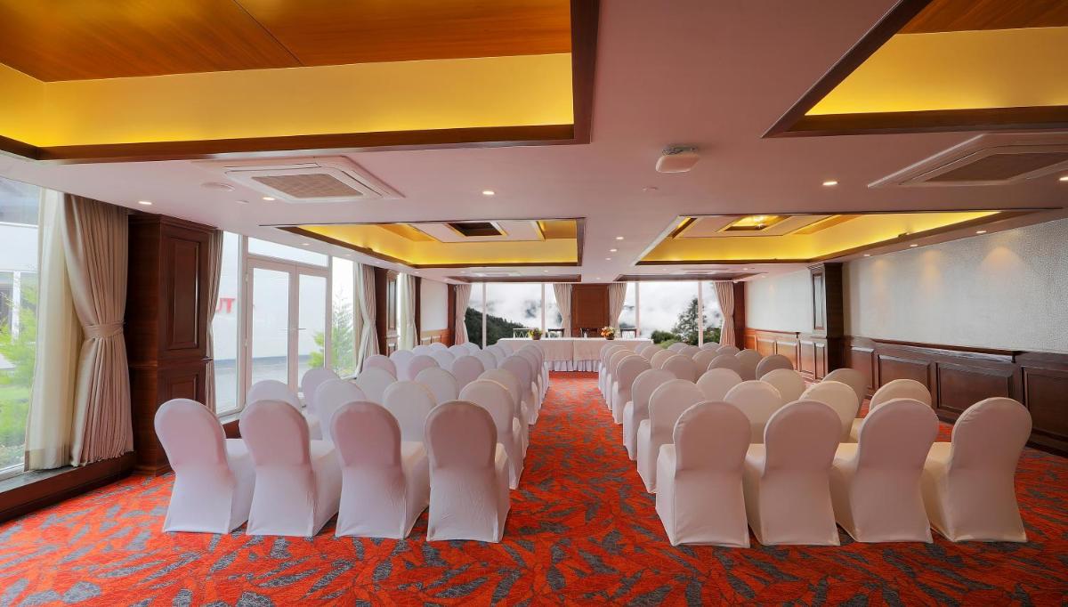 a conference room with white chairs in a room at Welcomhotel by ITC Hotels, Shimla in Shimla