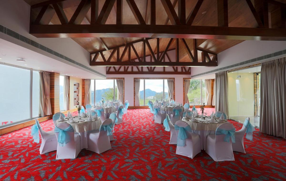 a room with a bunch of tables and chairs at Welcomhotel by ITC Hotels, Shimla in Shimla