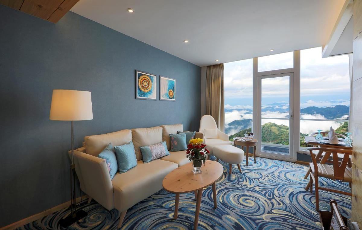 a living room with a couch and a table at Welcomhotel by ITC Hotels, Shimla in Shimla