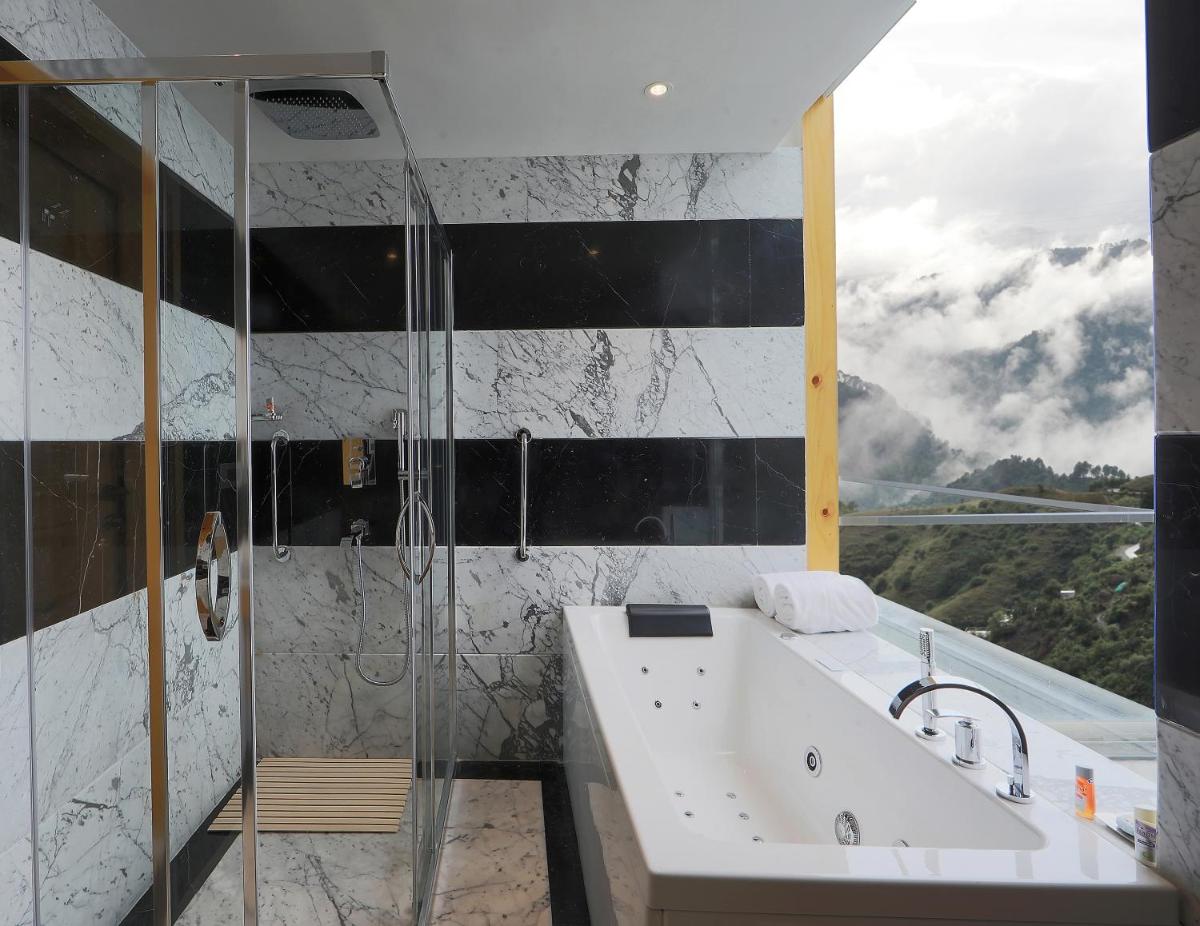 a bathroom with a shower and a tub and a sink at Welcomhotel by ITC Hotels, Shimla in Shimla
