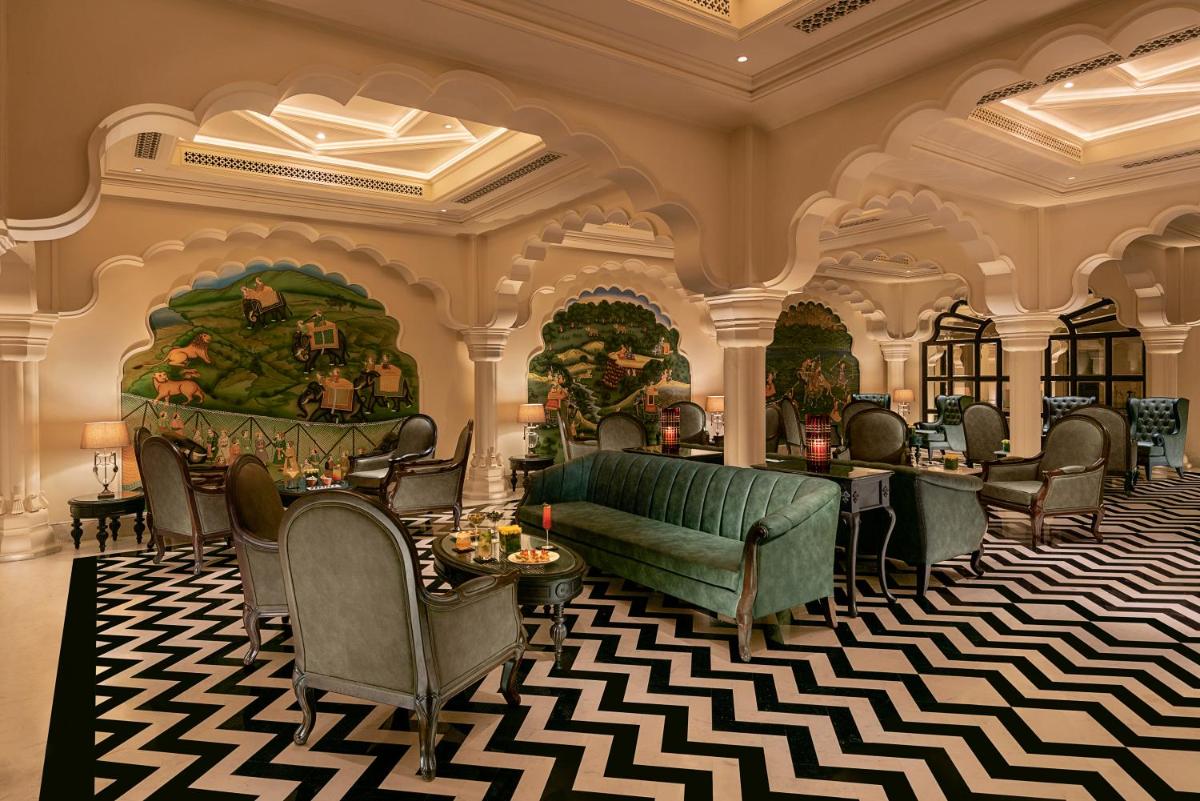 a lobby of a hotel with chairs and tables at Aurika, Udaipur - Luxury by Lemon Tree Hotels in Udaipur