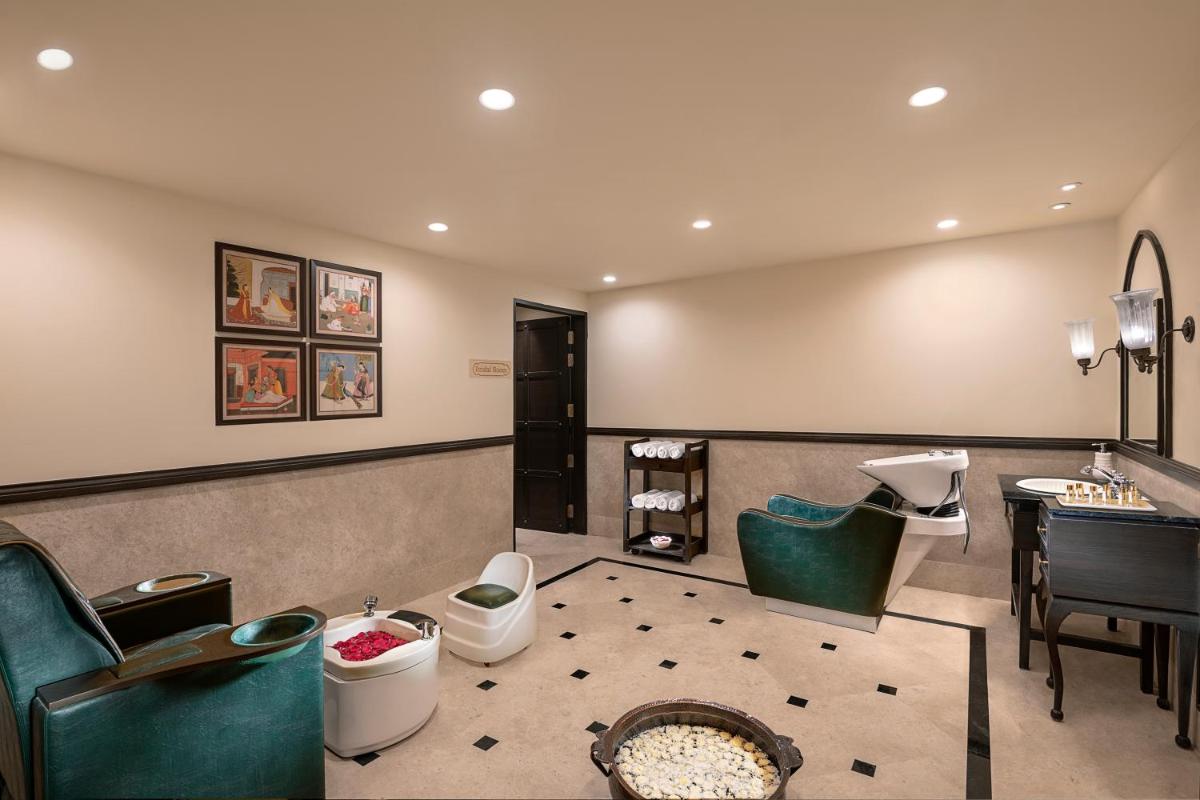 a waiting room with green chairs and a desk at Aurika, Udaipur - Luxury by Lemon Tree Hotels in Udaipur