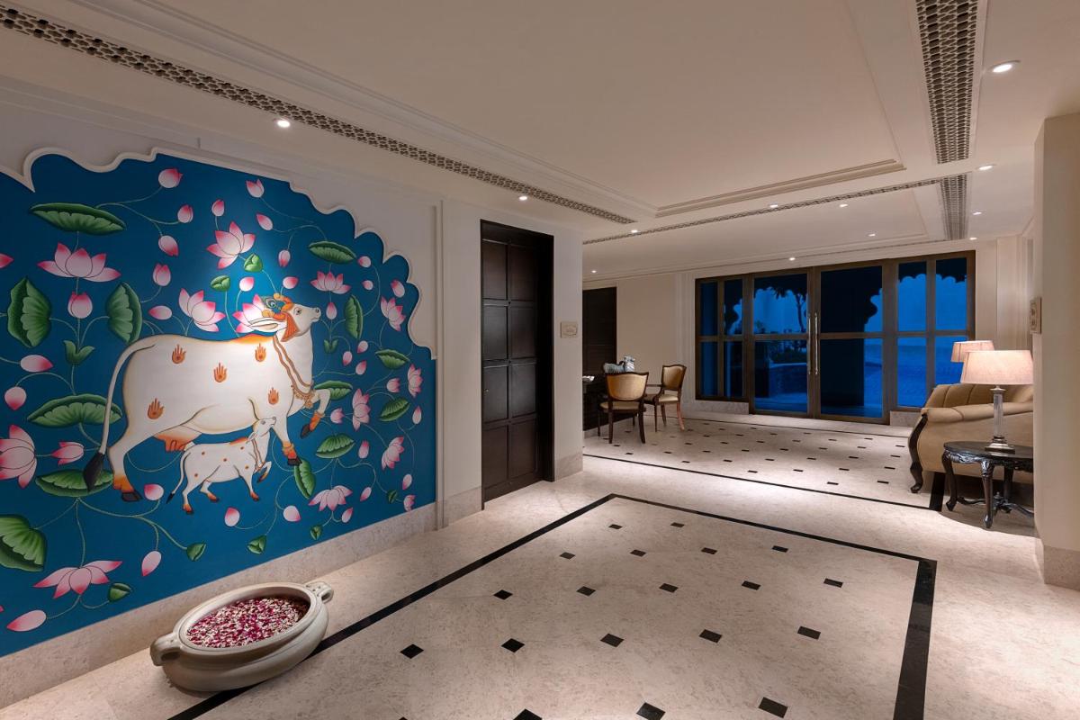 a room with a mural of a cow on the wall at Aurika, Udaipur - Luxury by Lemon Tree Hotels in Udaipur
