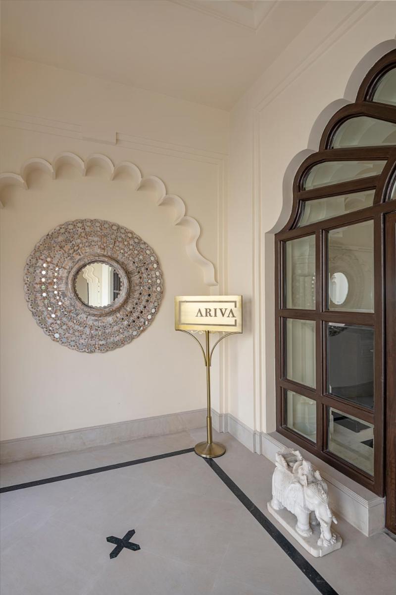 a room with a mirror and a sign on the wall at Aurika, Udaipur - Luxury by Lemon Tree Hotels in Udaipur