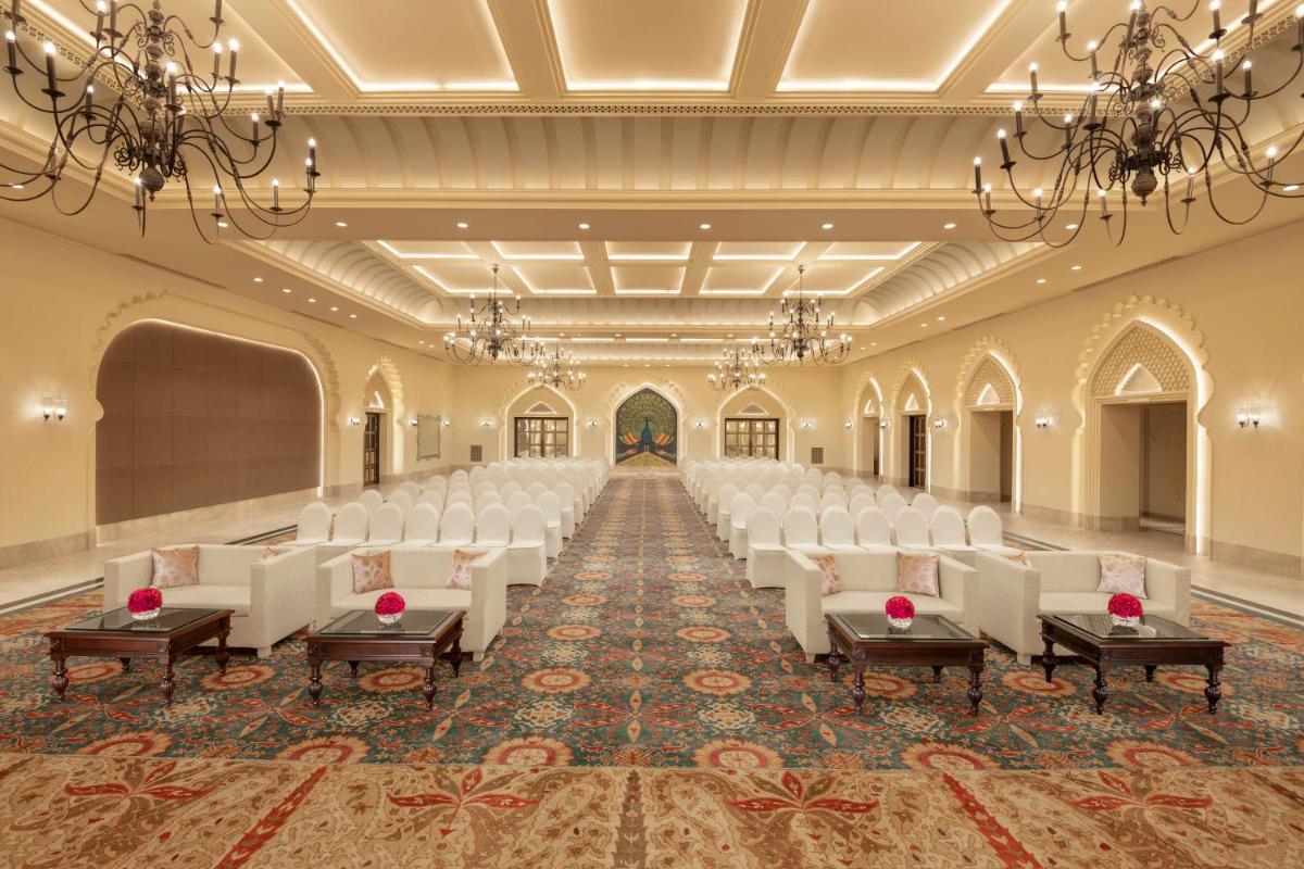 an empty banquet hall with white chairs and tables at Aurika, Udaipur - Luxury by Lemon Tree Hotels in Udaipur