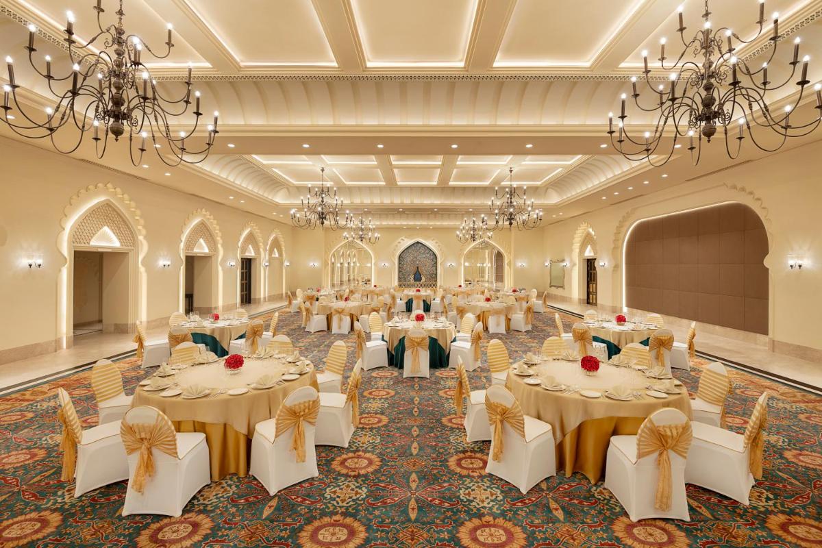 a banquet hall with tables and chairs and chandeliers at Aurika, Udaipur - Luxury by Lemon Tree Hotels in Udaipur +76 photos