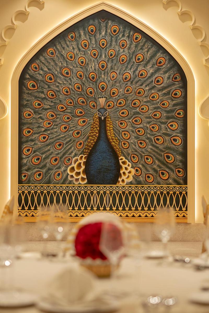 a picture of a wall with a peacock painting at Aurika, Udaipur - Luxury by Lemon Tree Hotels in Udaipur