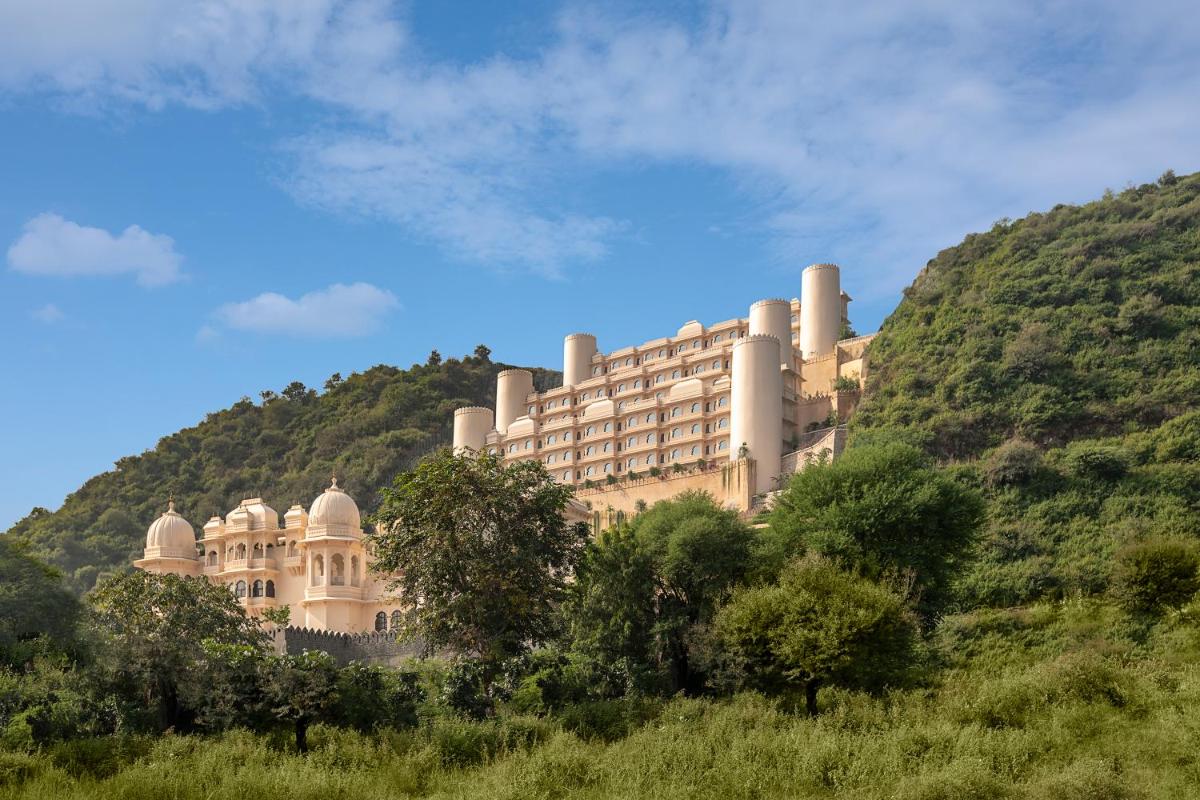 a large building on top of a hill at Aurika, Udaipur - Luxury by Lemon Tree Hotels in Udaipur