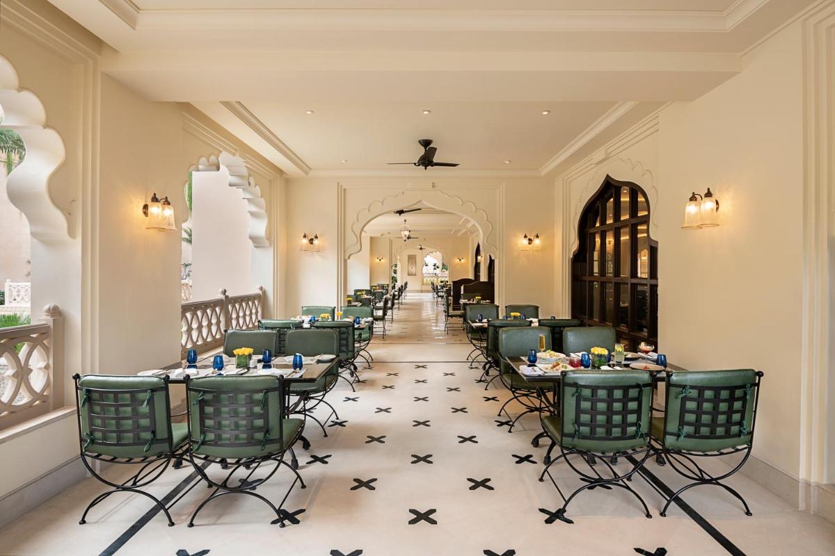 a row of tables and chairs in a restaurant at Aurika, Udaipur - Luxury by Lemon Tree Hotels in Udaipur