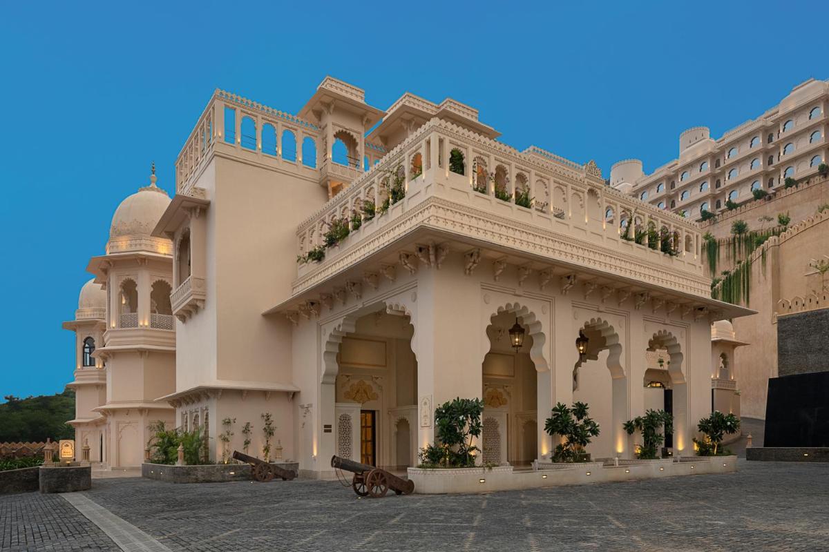 a large white building with a balcony on top at Aurika, Udaipur - Luxury by Lemon Tree Hotels in Udaipur