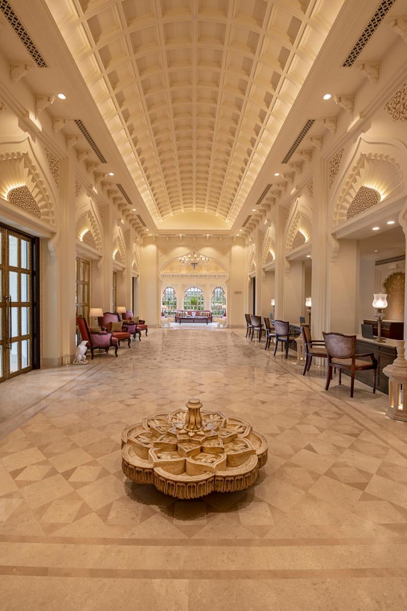 a large lobby with a table in the middle of it at Aurika, Udaipur - Luxury by Lemon Tree Hotels in Udaipur