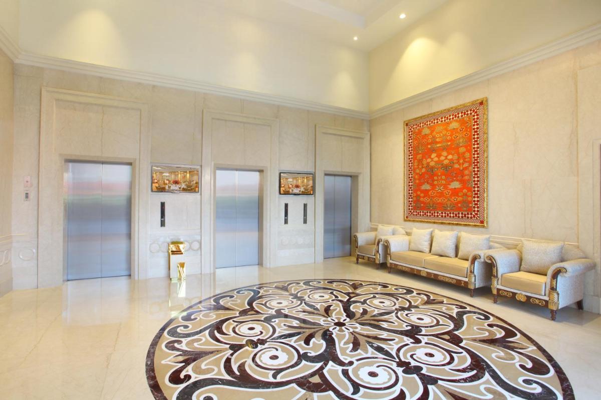 a large living room with couches and a rug at Seven Seas Hotel in New Delhi