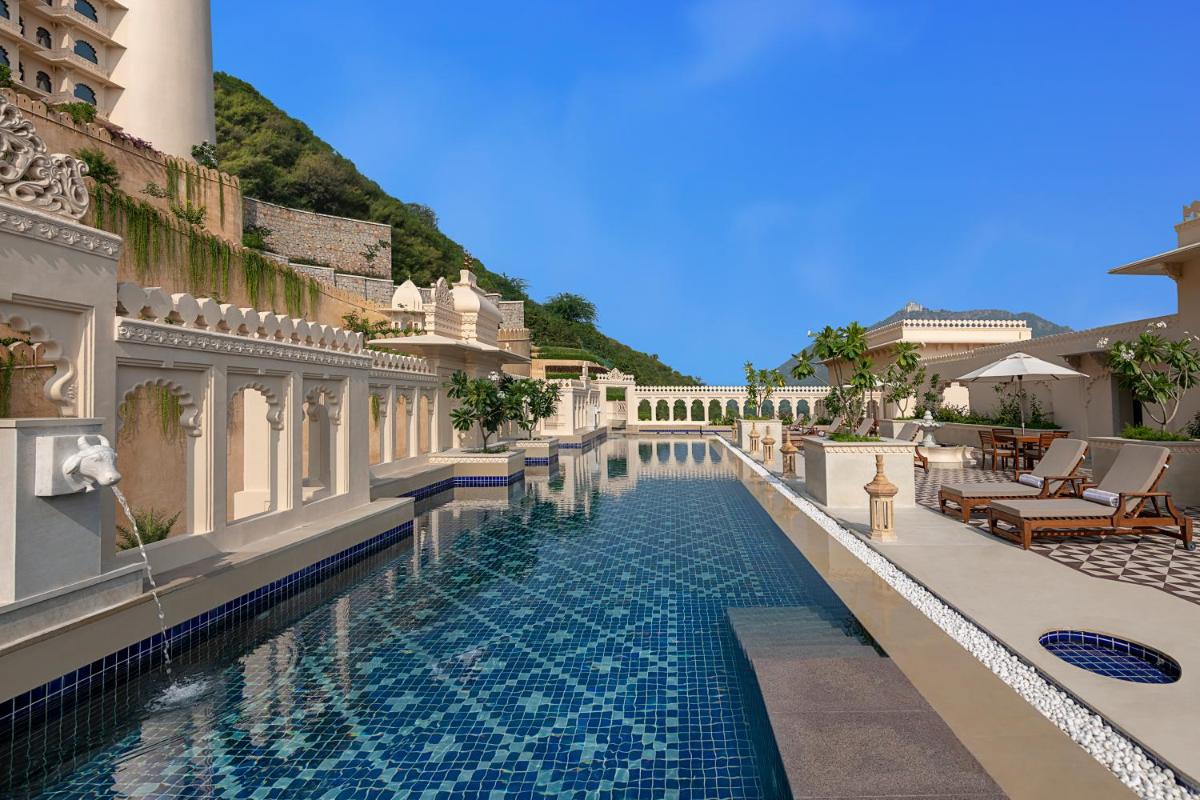 a swimming pool at a hotel with a resort at Aurika, Udaipur - Luxury by Lemon Tree Hotels in Udaipur