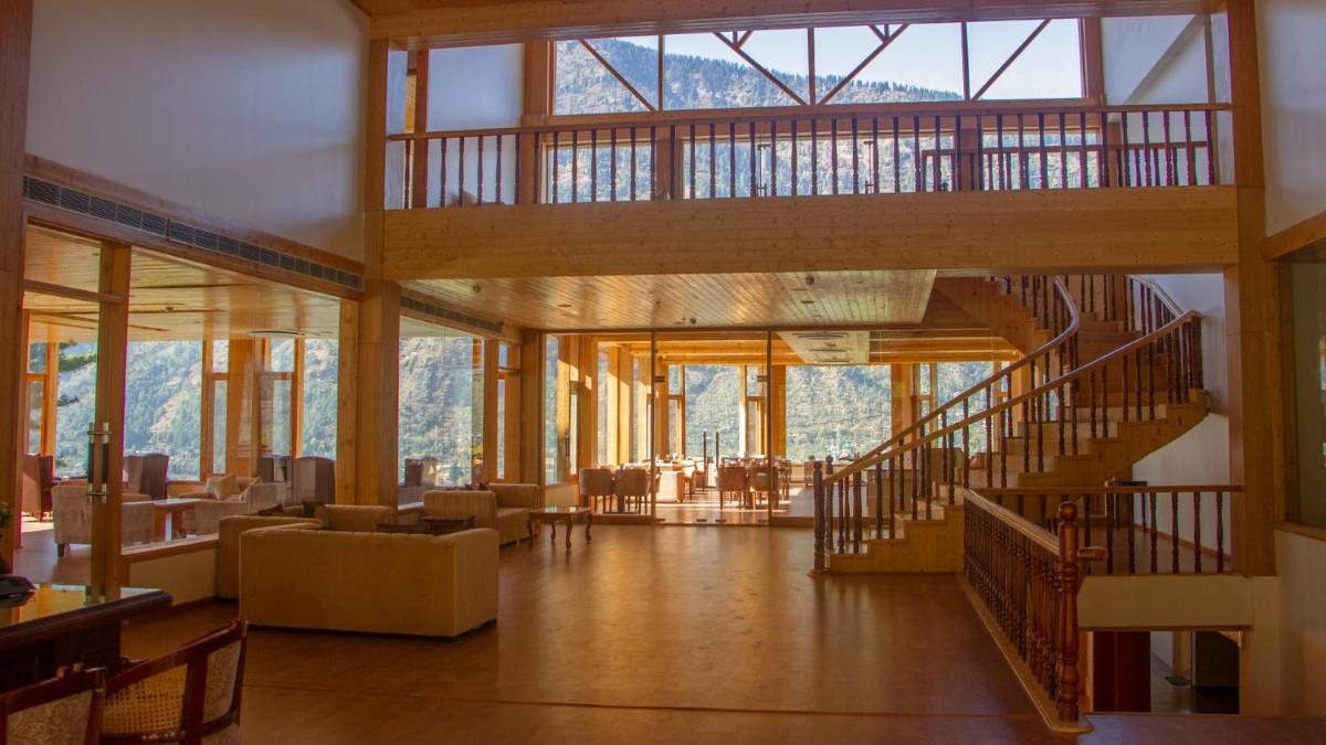 a large lobby with a staircase and a living room at Baragarh Resort & Spa, Manali- IHCL SeleQtions in Manāli